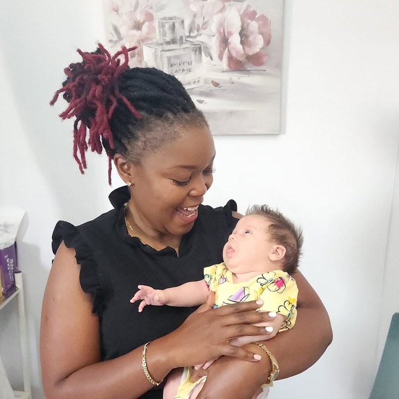 Staff member holding a baby patient